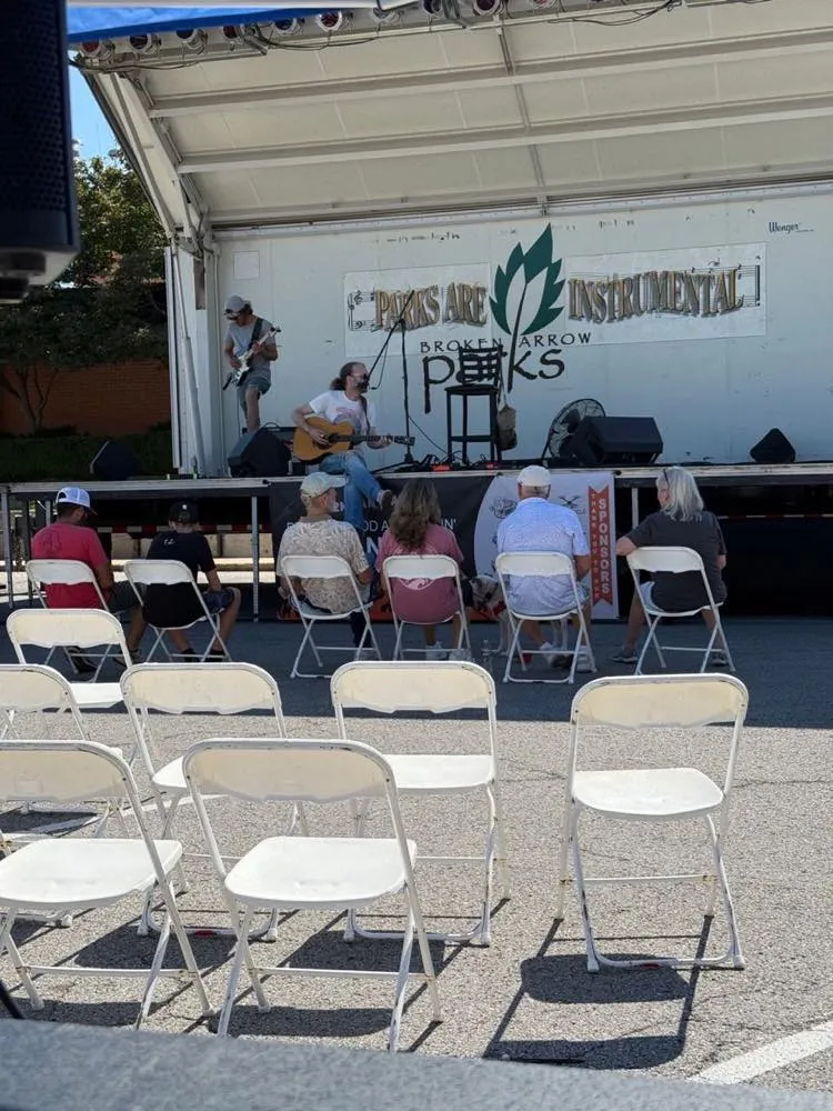 Daytime acoustic performance on a mobile stage produced by Phase 3 Live for a parks concert series.