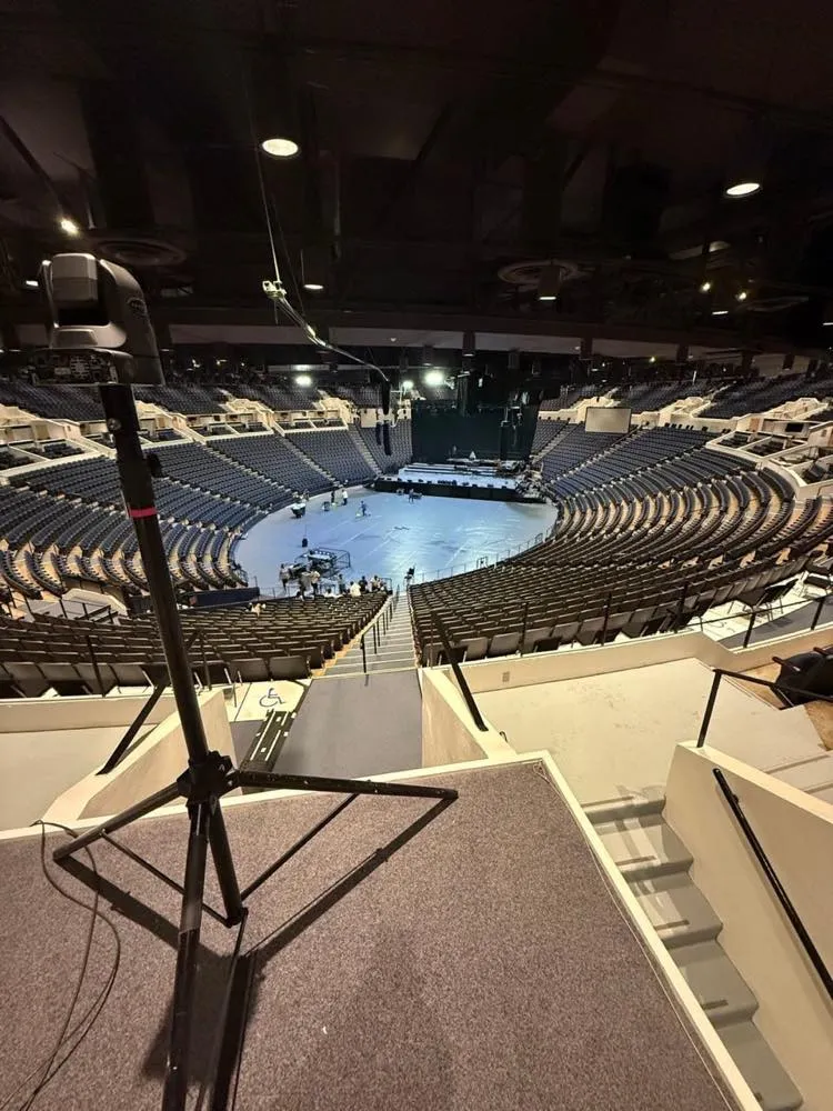 Broadcast camera positioned high in an arena during event setup by Phase 3 Live