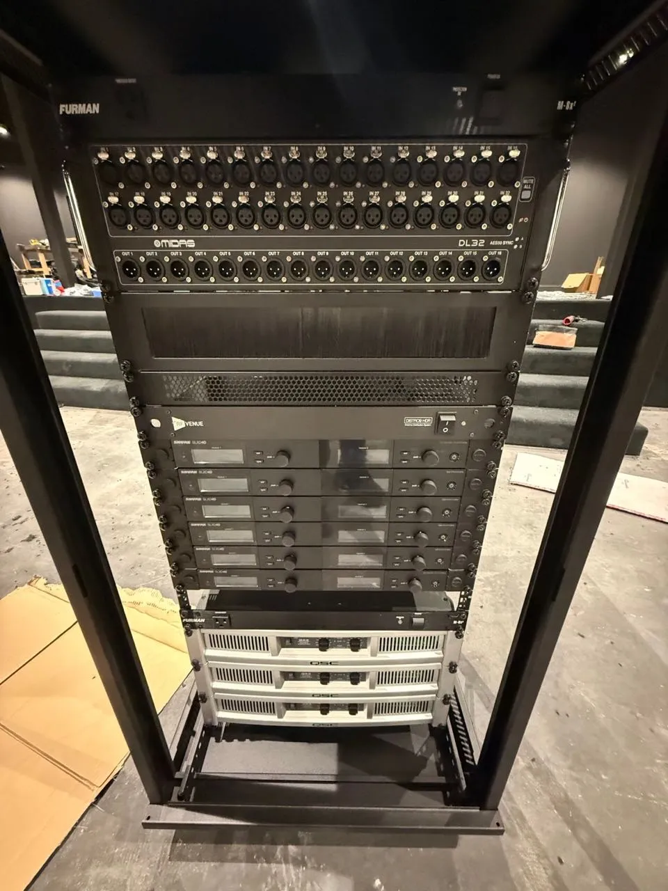 Rack-mounted Midas DL32 stage box, Shure wireless systems, and QSC amplifiers installed by Phase 3 Live.