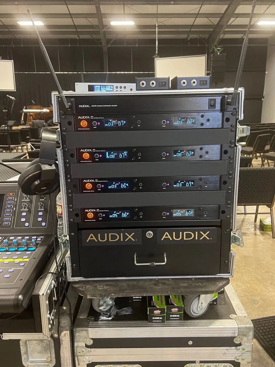 Rack of Audix wireless microphone receivers in a road case, part of Phase 3 Live's audio inventory