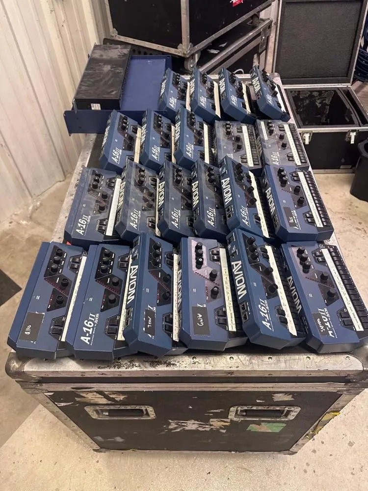 Aviom A-16II personal monitor mixers staged on a road case in the Phase 3 Live equipment warehouse.
