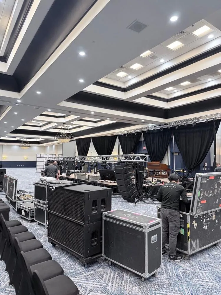 Phase 3 Live crew loading in speakers, road cases, and truss for a ballroom stage build