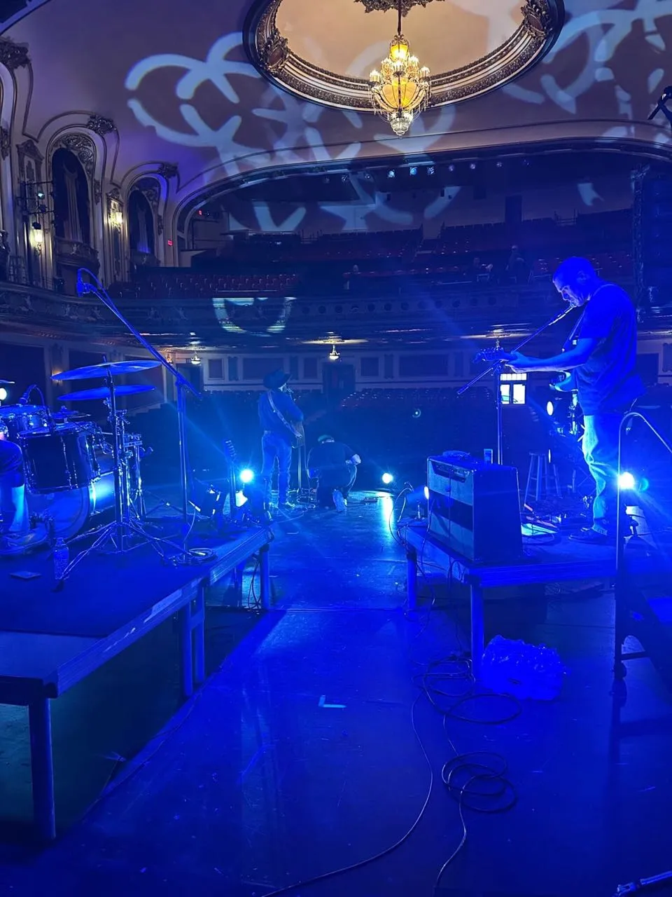 Blue stage wash over a band soundcheck produced by Phase 3 Live in a historic domed theater.