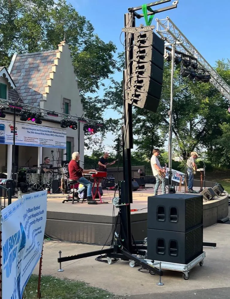 Outdoor blues festival stage with crank-up line array tower and sound by Phase 3 Live