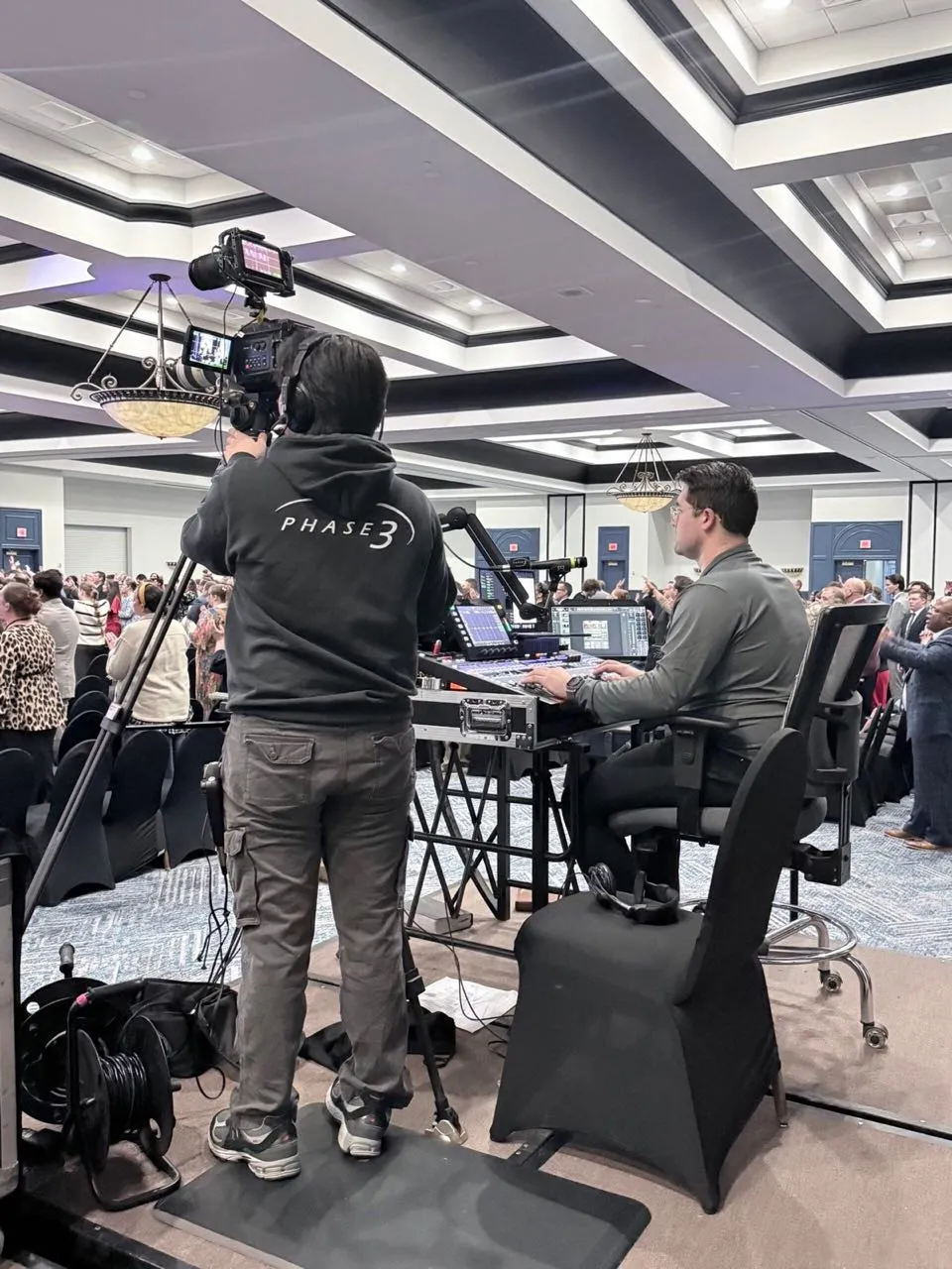 Phase 3 Live camera operator and broadcast engineer working a live convention session