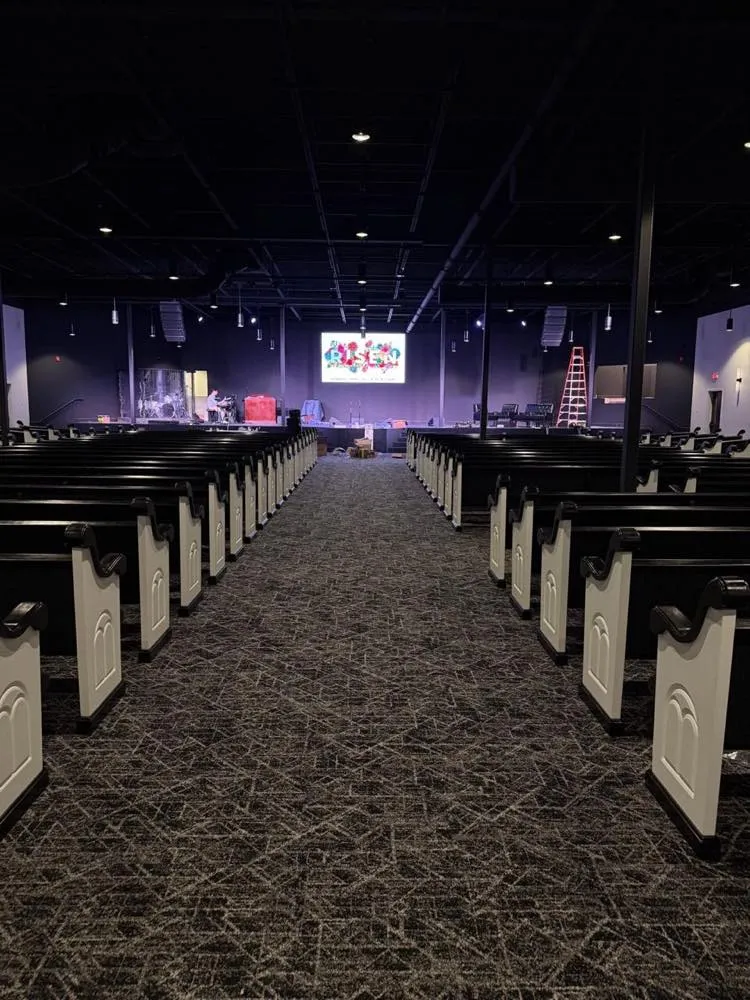 Center aisle of a church sanctuary with an LED video wall installed by Phase 3 Live displaying a colorful graphic above the stage.