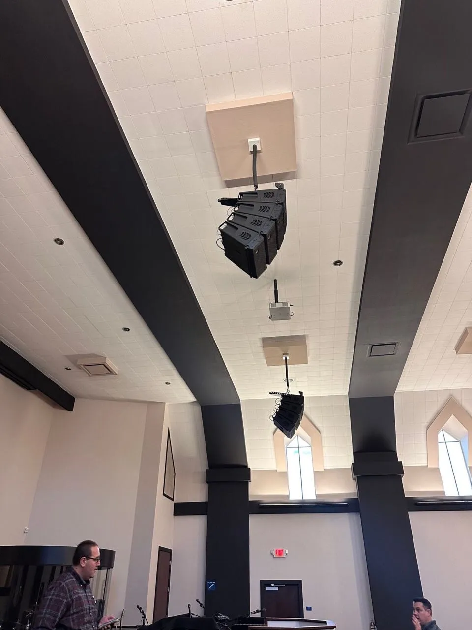 Line array speakers installed overhead in a church sanctuary by Phase 3 Live