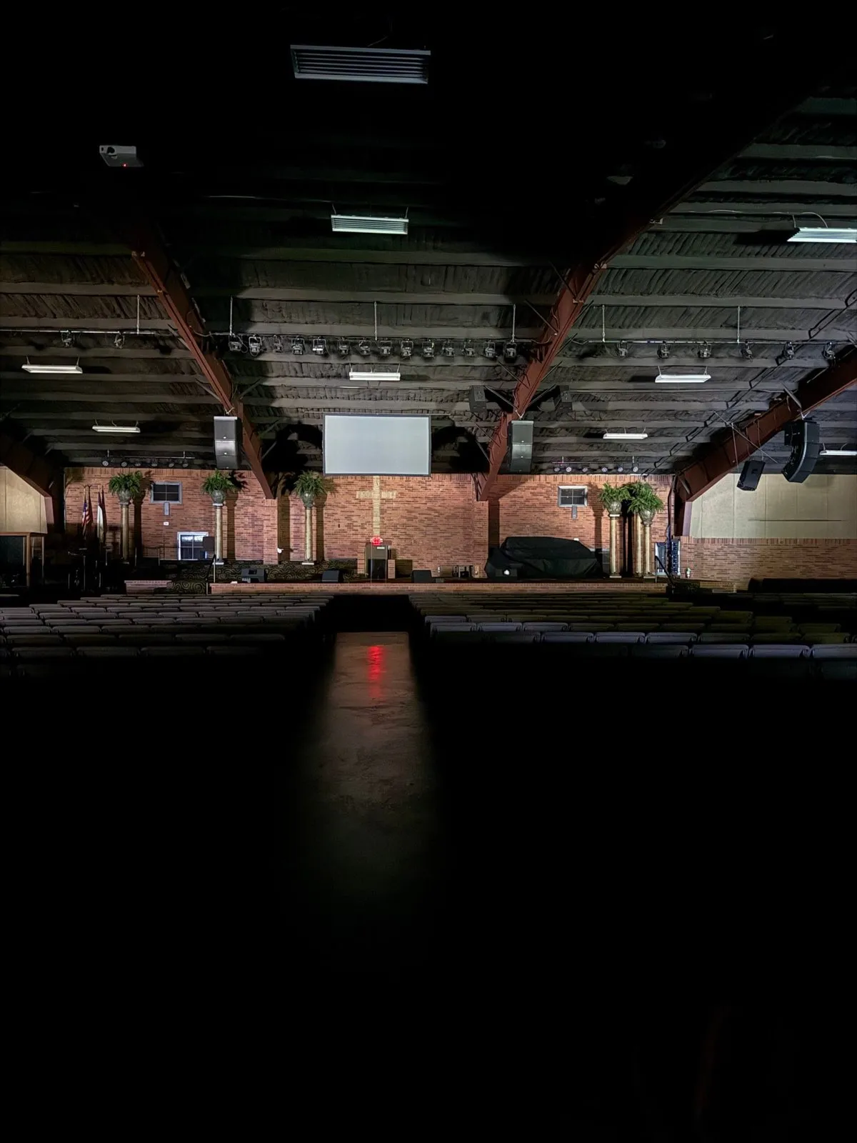 Church sanctuary with speaker clusters and projection screen during a Phase 3 Live AV installation