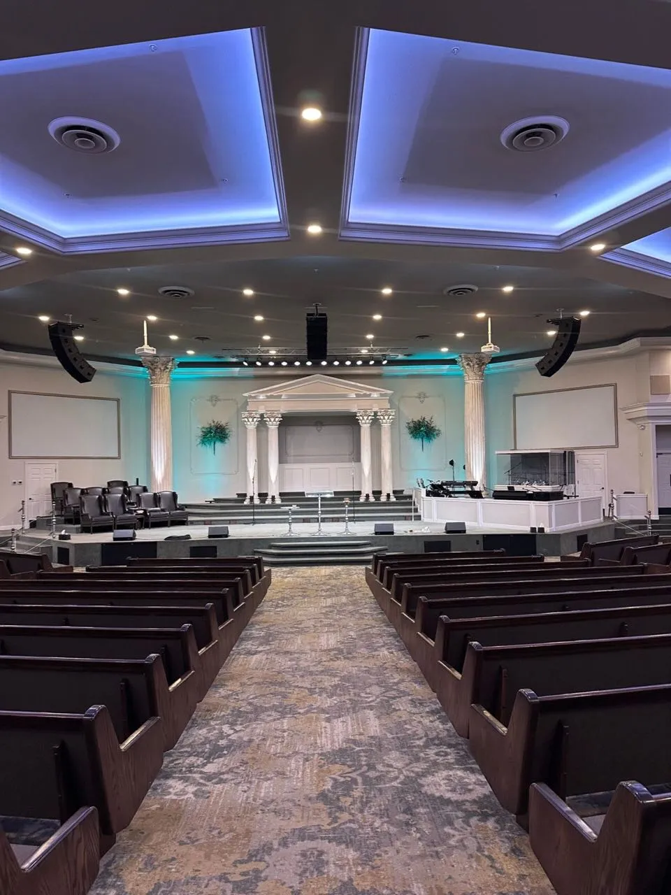 Church sanctuary with teal accent lighting and line arrays installed by Phase 3 Live
