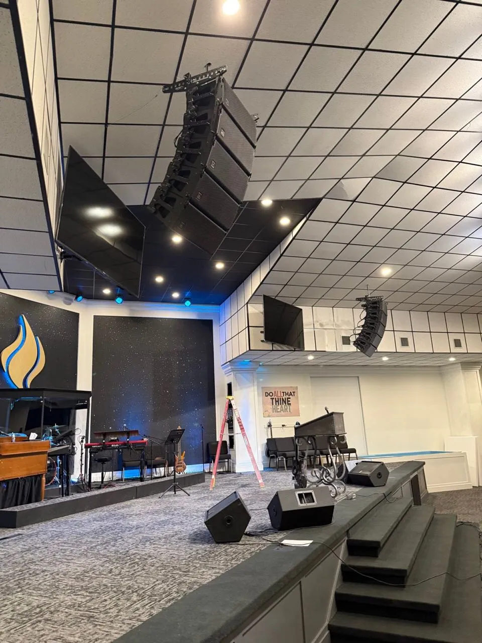 Line arrays flown above a church stage during a Phase 3 Live install