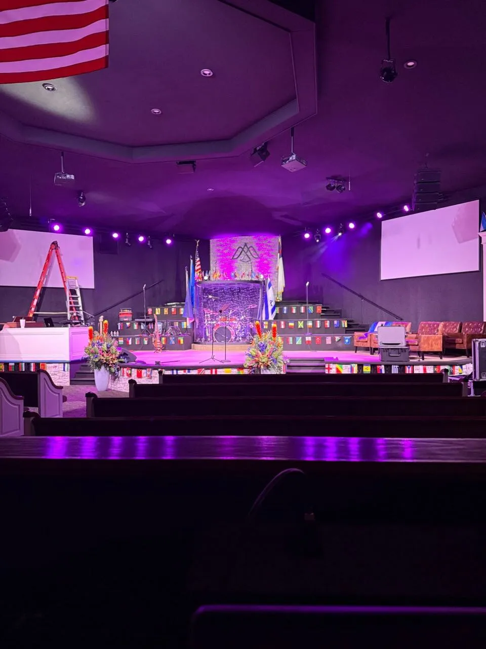 Purple stage lighting wash across a church sanctuary platform produced by Phase 3 Live