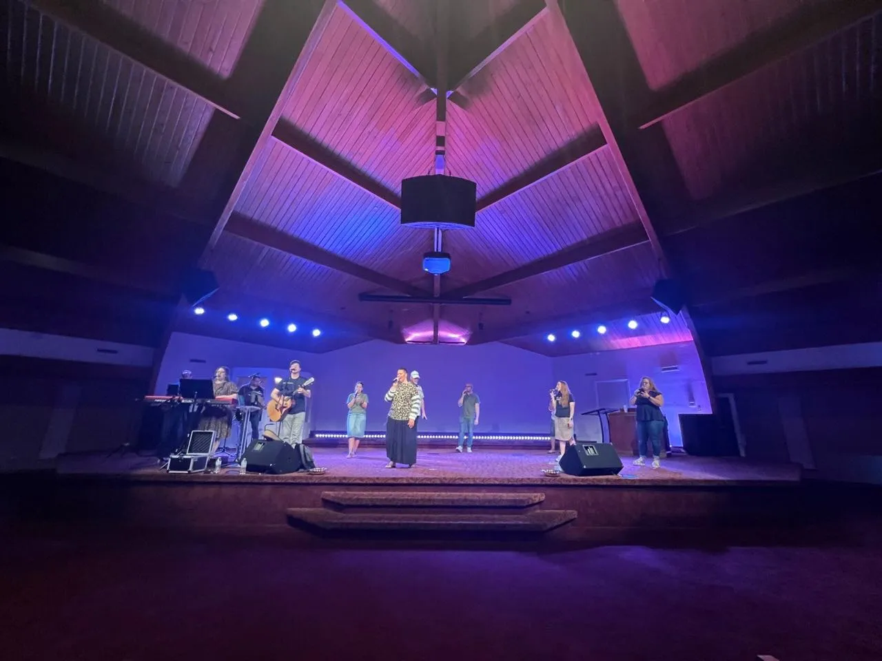 Church worship team on stage under purple and blue event lighting supported by Phase 3 Live