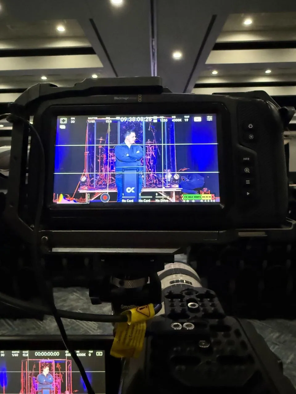 Blackmagic cinema camera framing a speaker on stage during live video production by Phase 3 Live.