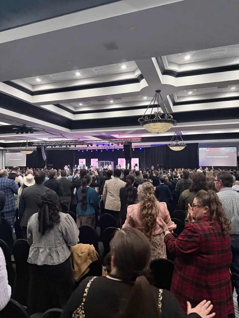 Capacity crowd at a convention service with staging and screens produced by Phase 3 Live