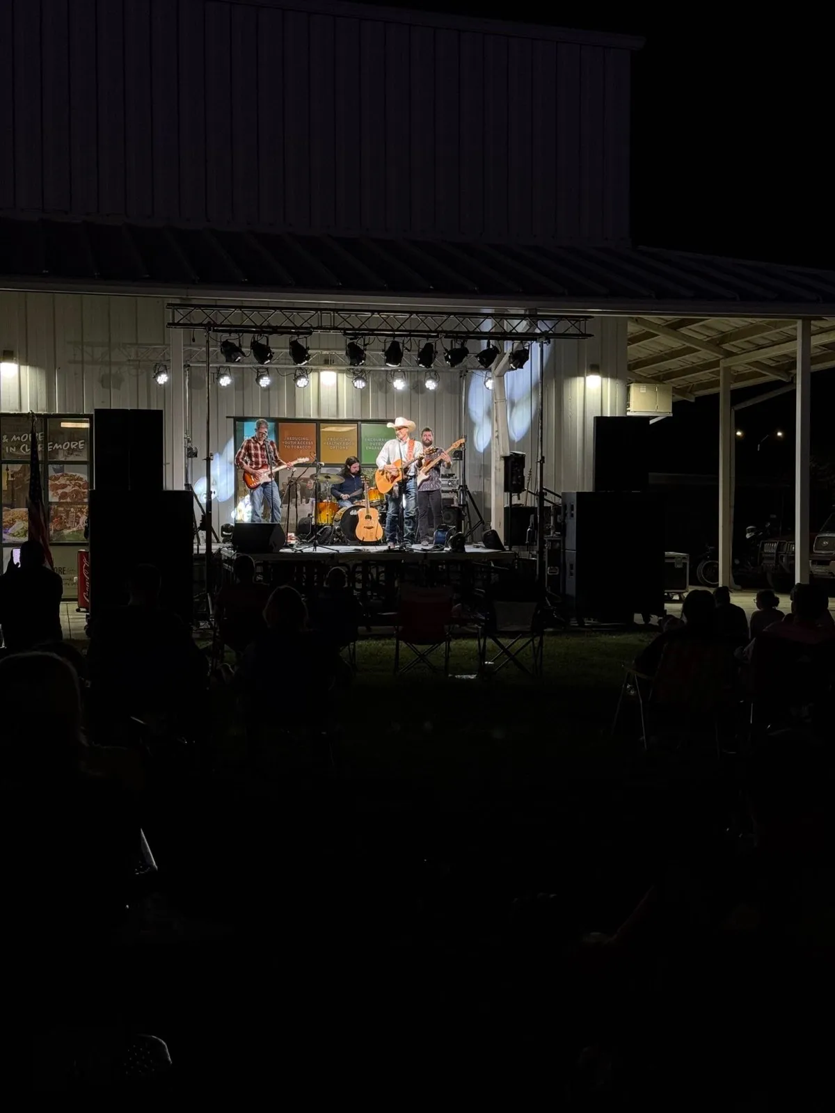 Country band on a Phase 3 Live portable stage with concert lighting at an outdoor night show
