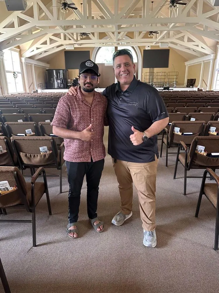 Phase 3 Live crew member and a guest giving thumbs-up in a church sanctuary