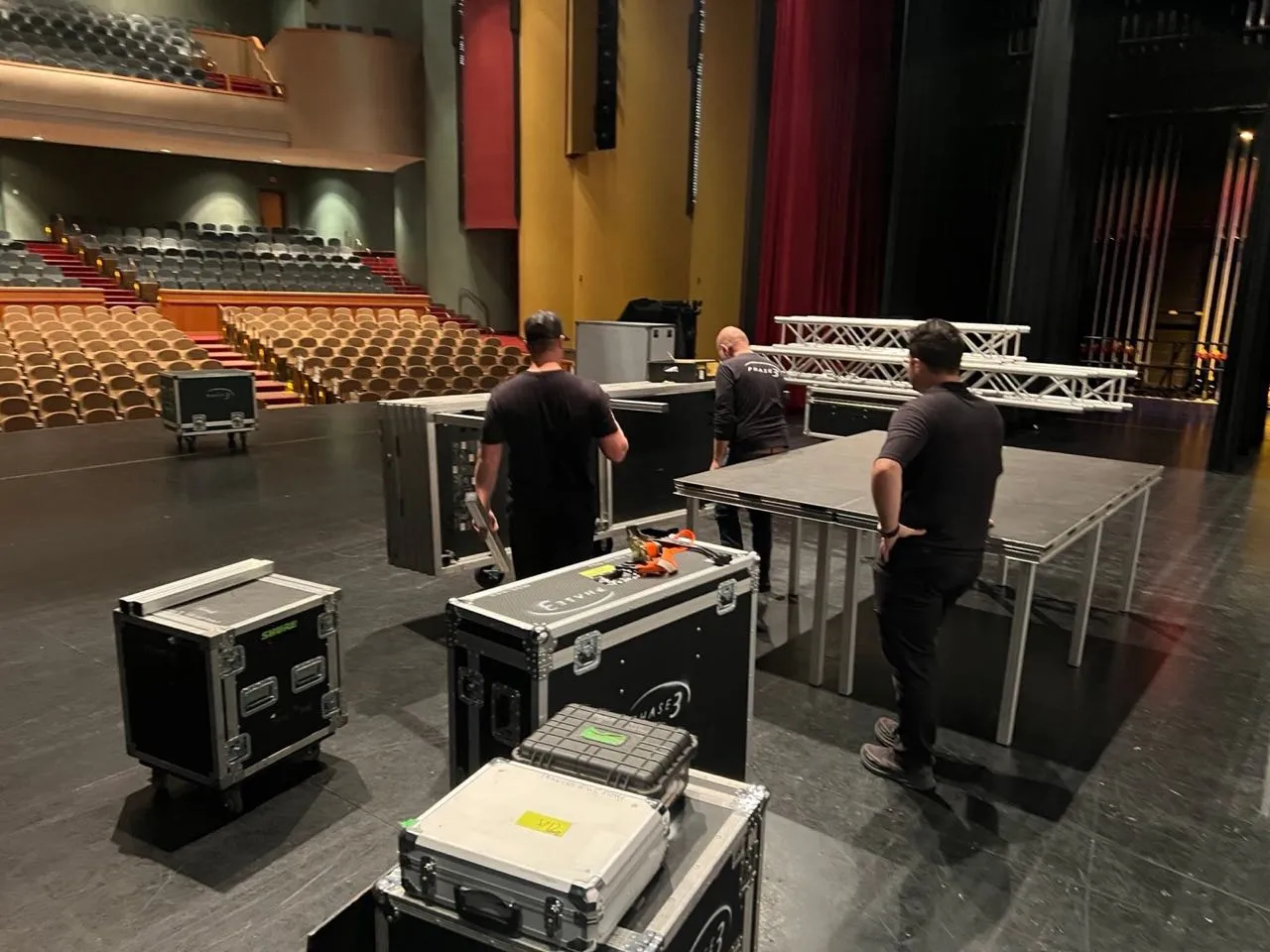 Phase 3 Live crew assembling staging and truss in a theater before an event