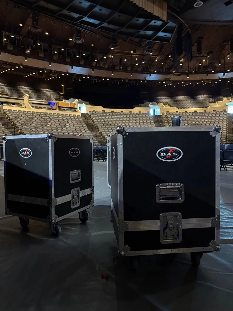 D.A.S. Audio speaker road cases on an arena floor during a Phase 3 Live event load-in