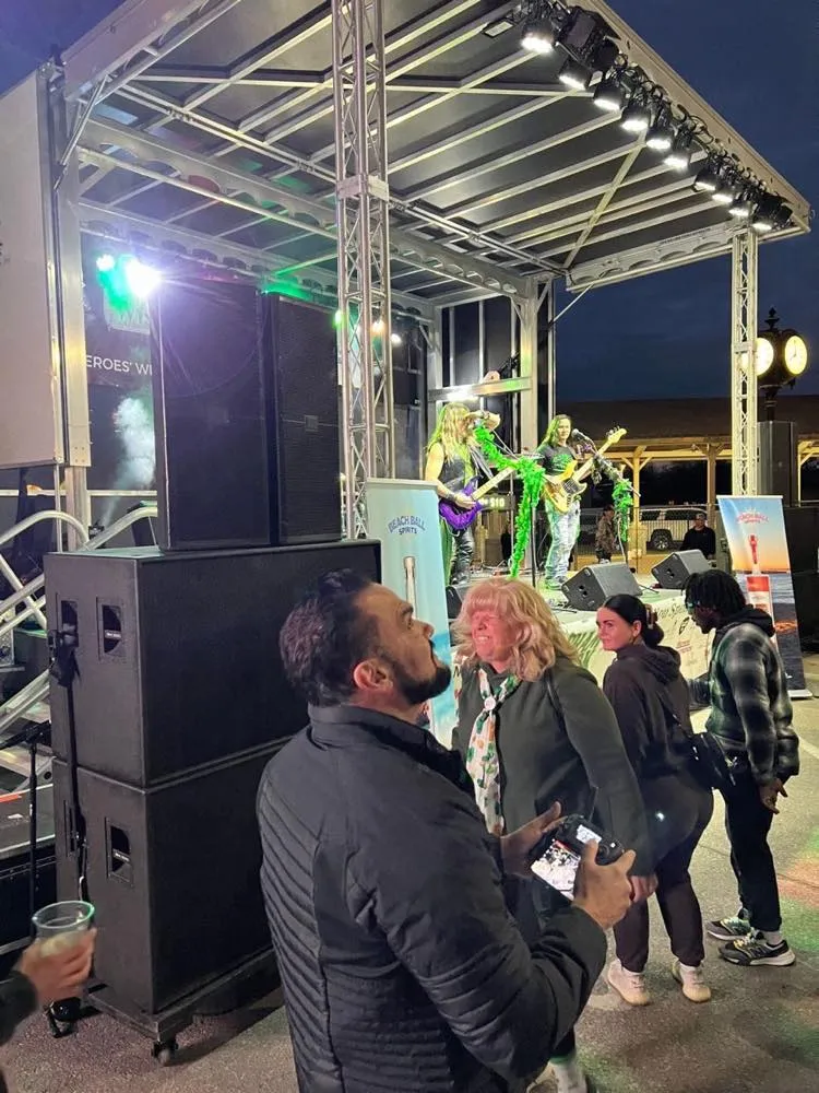 Band performing at dusk on a Phase 3 Live mobile stage during an outdoor street festival