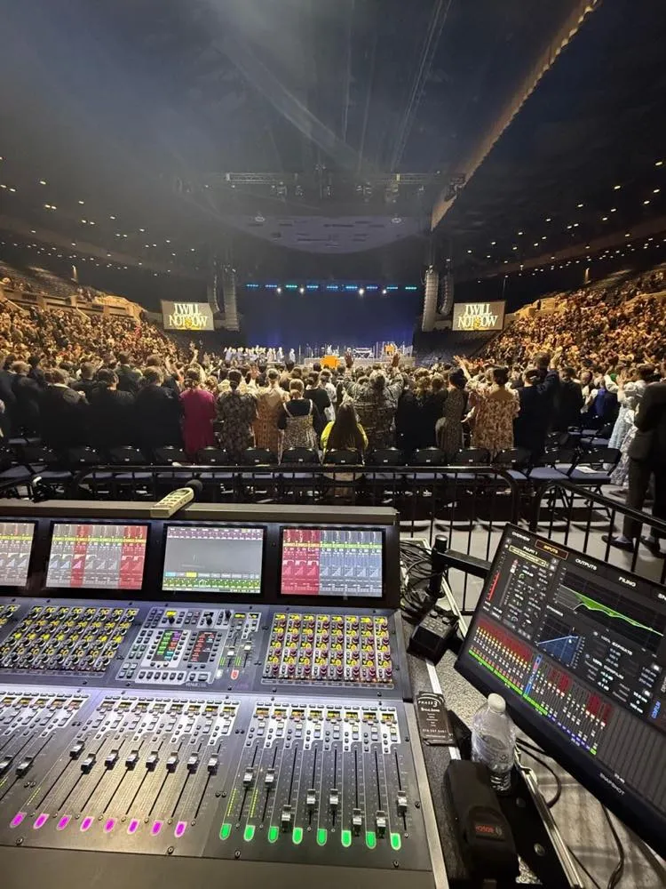 Front-of-house console overlooking a packed arena crowd at a Phase 3 Live event