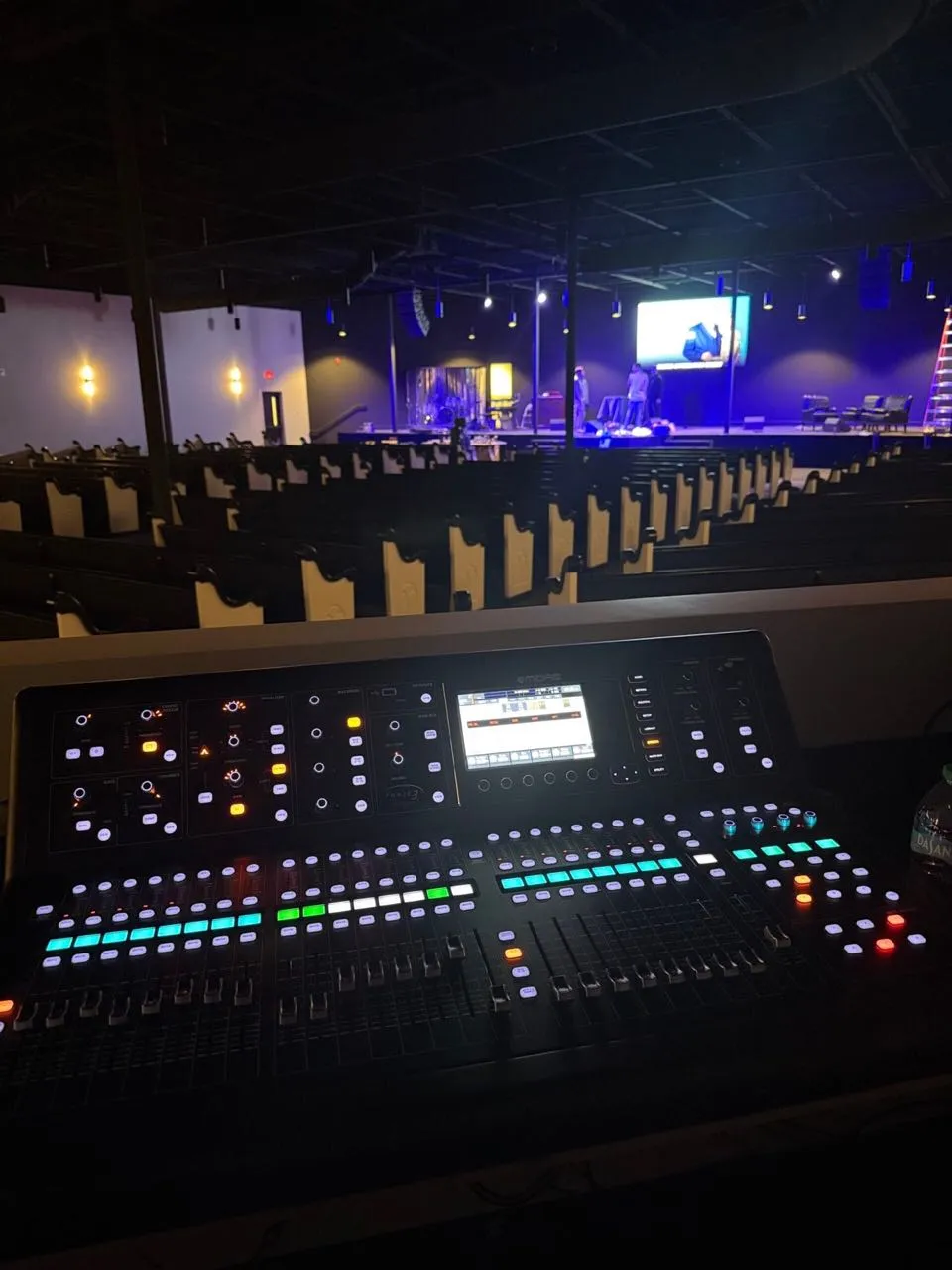 Digital mixing console at front of house overlooking a church sanctuary outfitted by Phase 3 Live.
