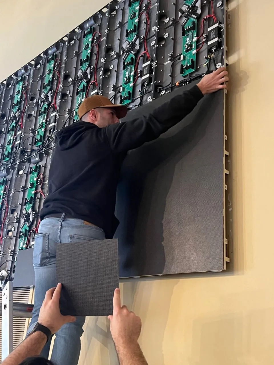 Phase 3 Live crew mounting LED panel modules onto an indoor video wall