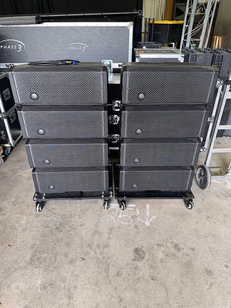 Stacked line array speaker cabinets ready for transport in the Phase 3 Live warehouse