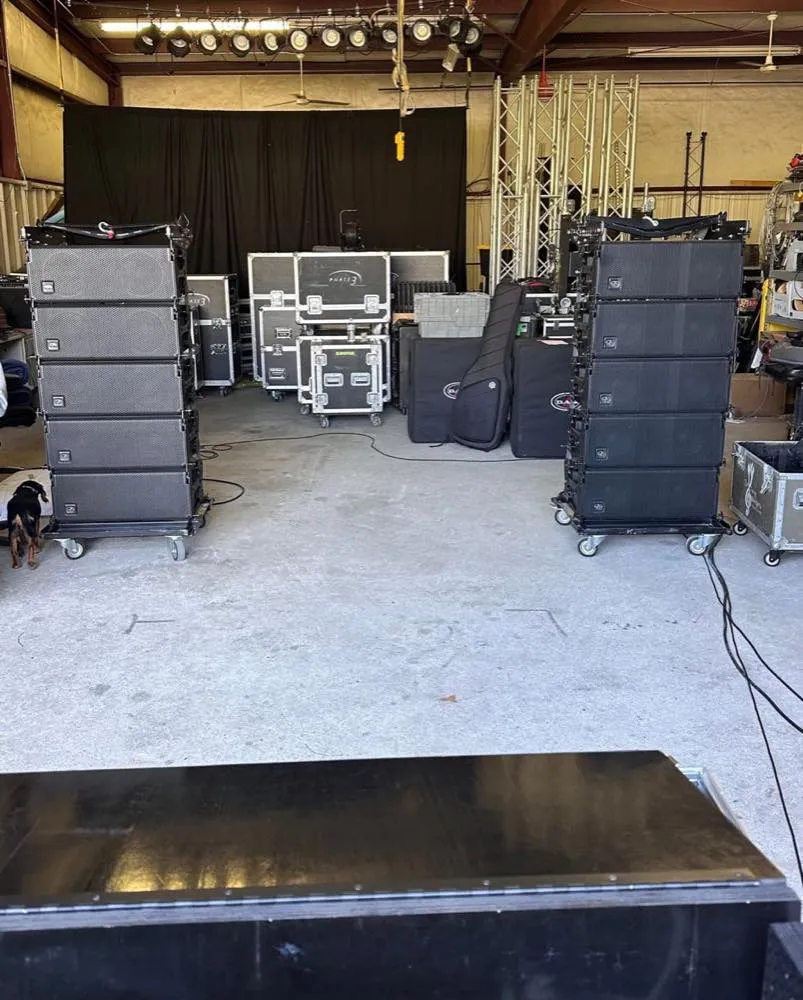 Line array speaker stacks and road cases in the Phase 3 Live equipment warehouse