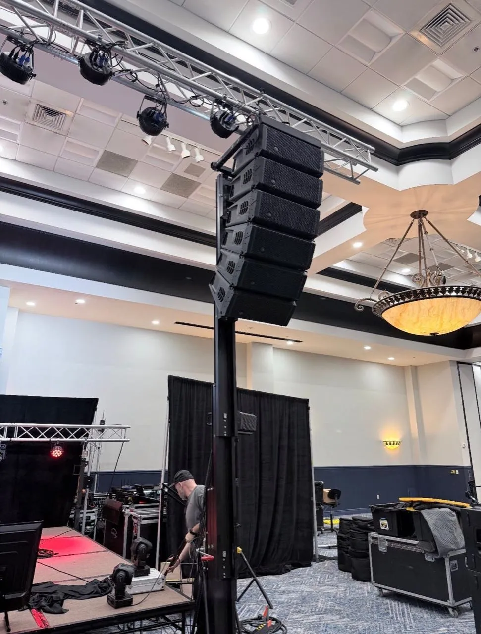 Line array and lighting truss on a ground-support tower rigged by Phase 3 Live in a hotel ballroom.