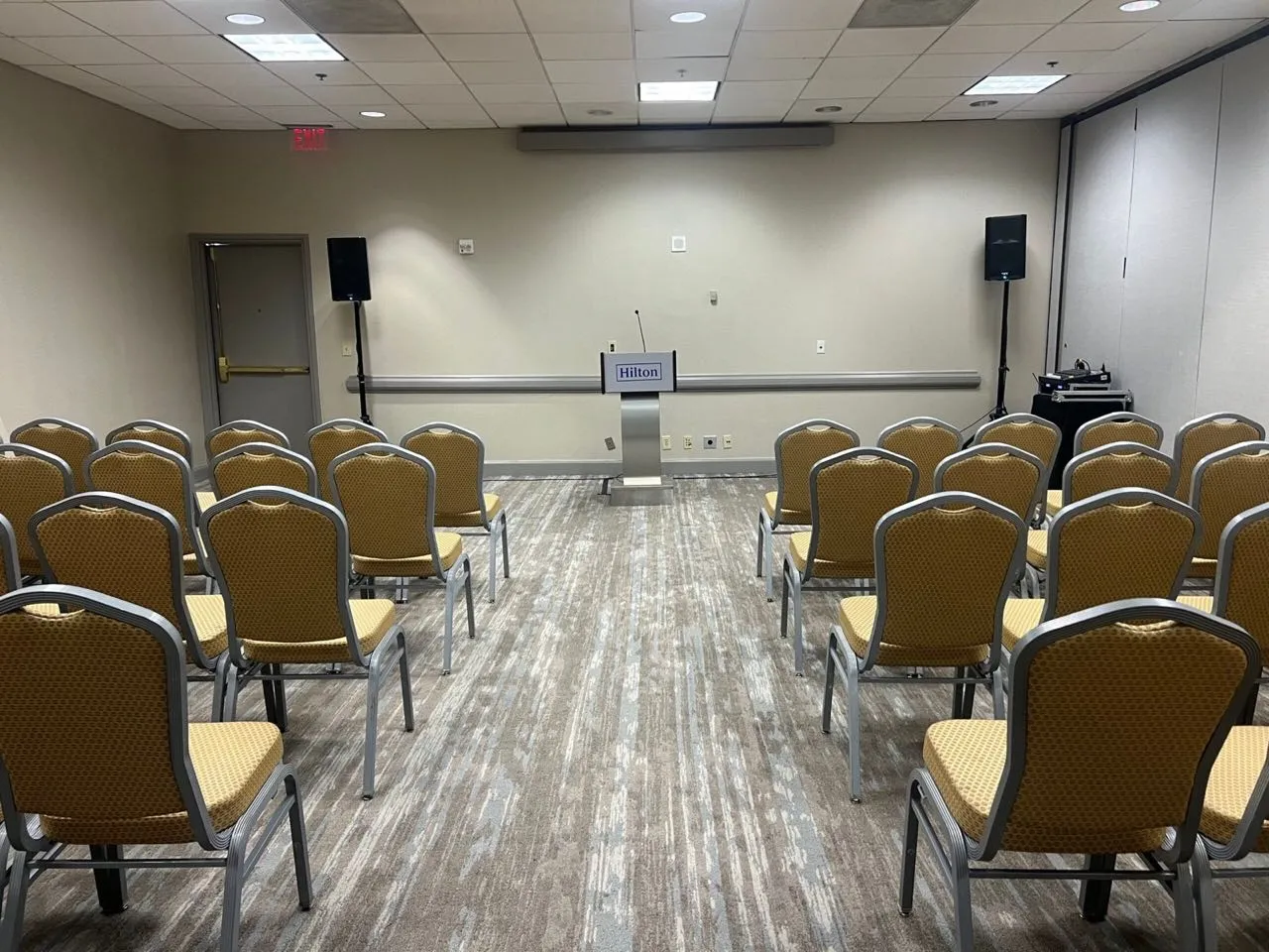 Corporate meeting room A/V setup by Phase 3 Live with lectern microphone and speakers on stands