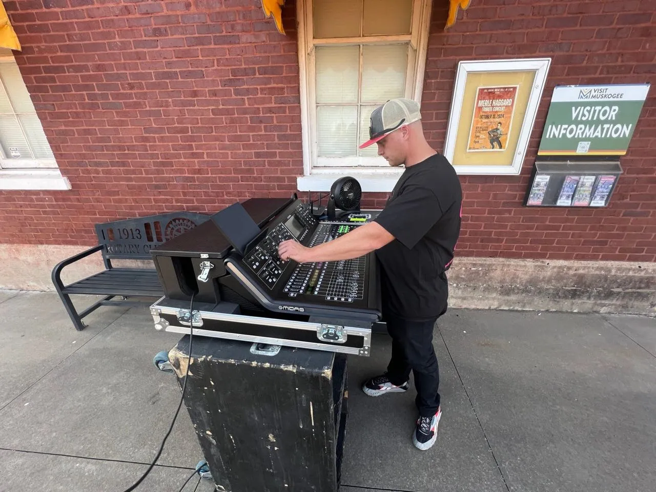 Phase 3 Live engineer mixing on a Midas console at an outdoor downtown event in Muskogee.