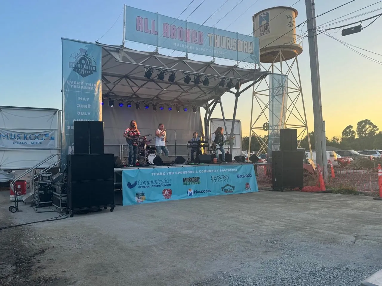 Band performing on a mobile stage with sound and lighting by Phase 3 Live at the All Aboard Thursday concert series in Muskogee's Depot District