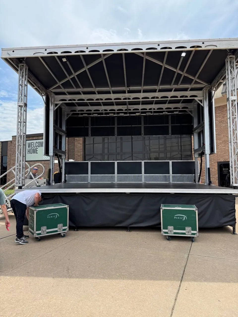 Phase 3 Live mobile stage trailer deployed outdoors with branded road cases during setup