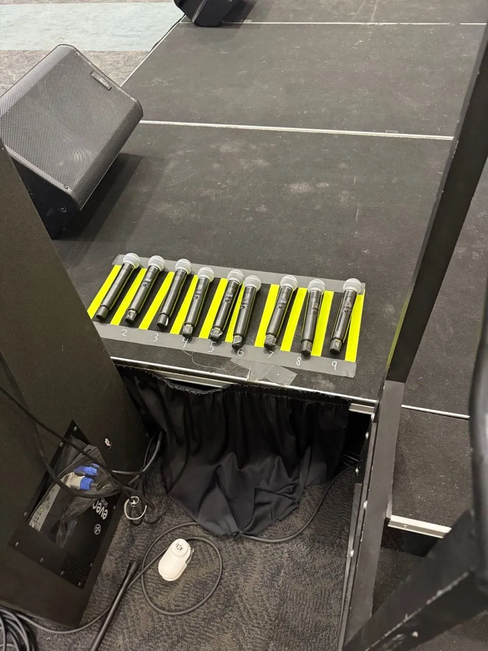 Numbered wireless microphones staged by Phase 3 Live before an event