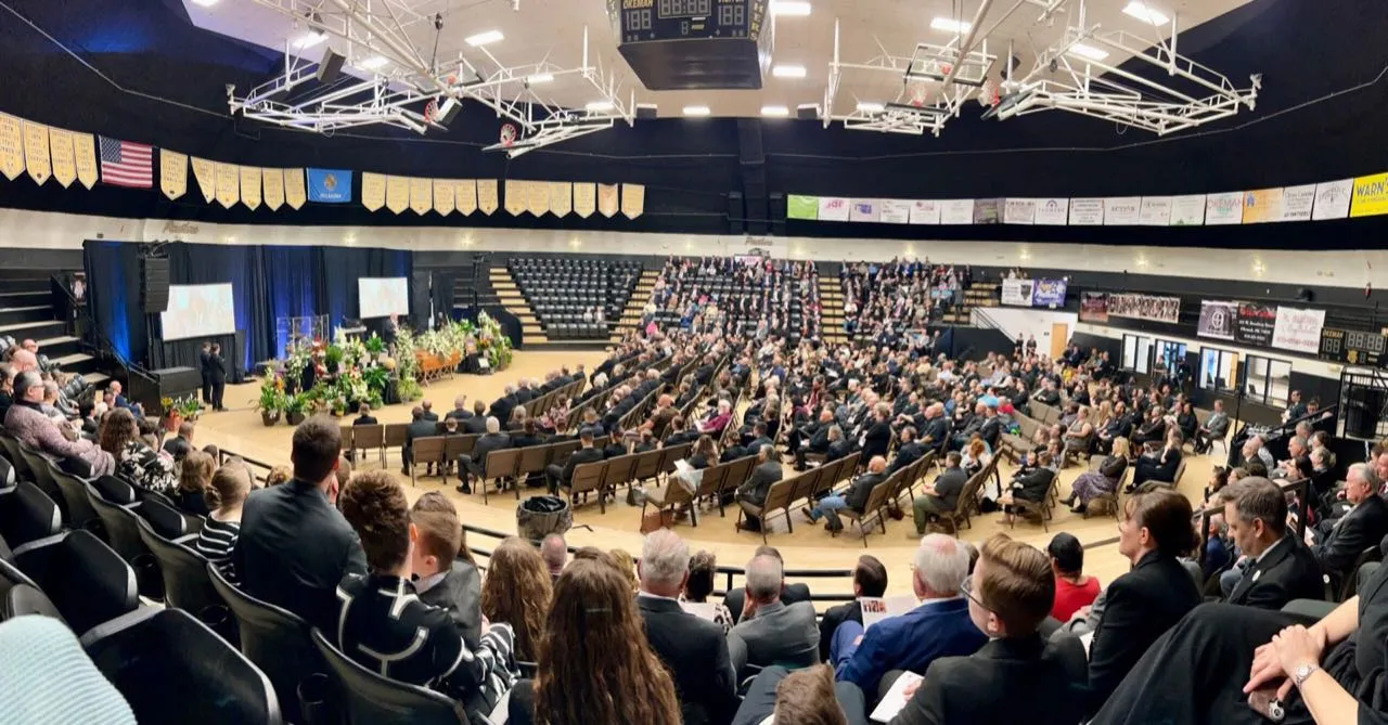 Large indoor gathering in a packed arena with staging and sound production support from Phase 3 Live