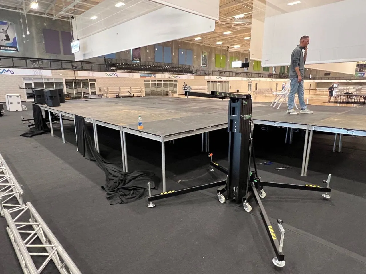 Phase 3 Live stage decking and lift tower being assembled inside a sports complex