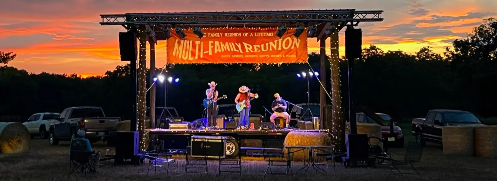 Outdoor festival stage with lighting and sound produced by Phase 3 Live under a sunset sky
