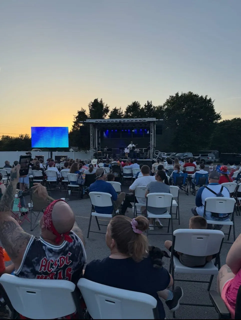 Outdoor community concert at sunset with mobile stage and LED screen produced by Phase 3 Live