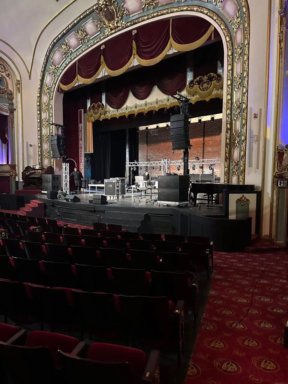 Line arrays rigged by Phase 3 Live frame the stage of a historic theater ahead of a concert.