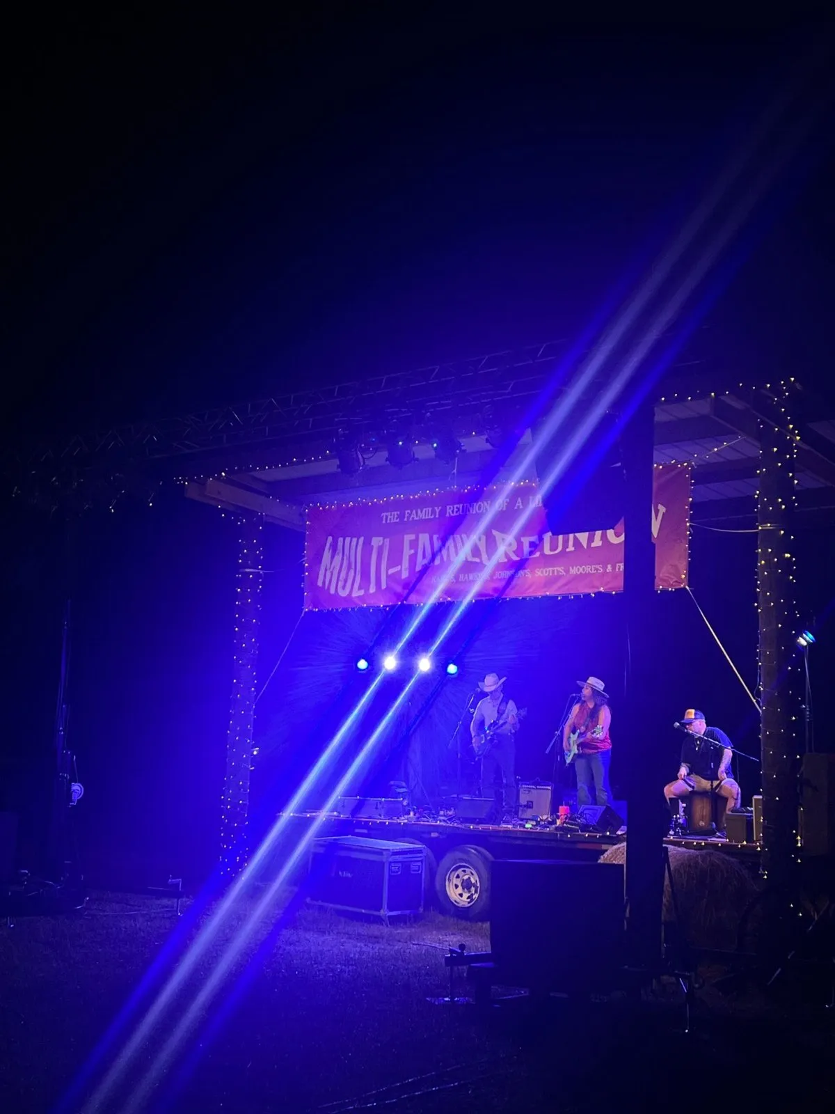 Band performs on a trailer stage at a night family reunion event with lighting and sound by Phase 3 Live