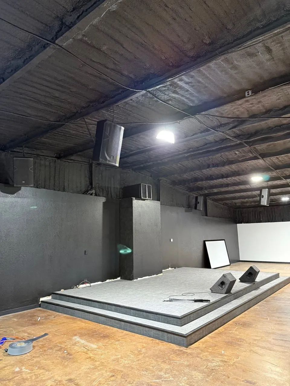 Newly built stage with ceiling-hung speakers and monitors installed by Phase 3 Live