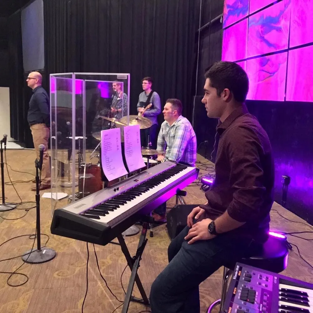 Worship band on stage with an LED video wall and stage lighting supported by Phase 3 Live